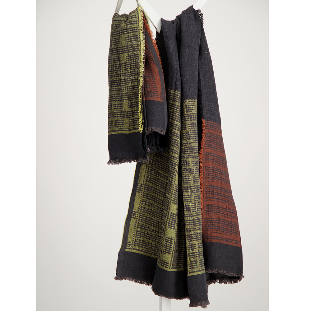 Chartreuse and rust on charcoal bogowrap linen scarf hanged on a coat rack
