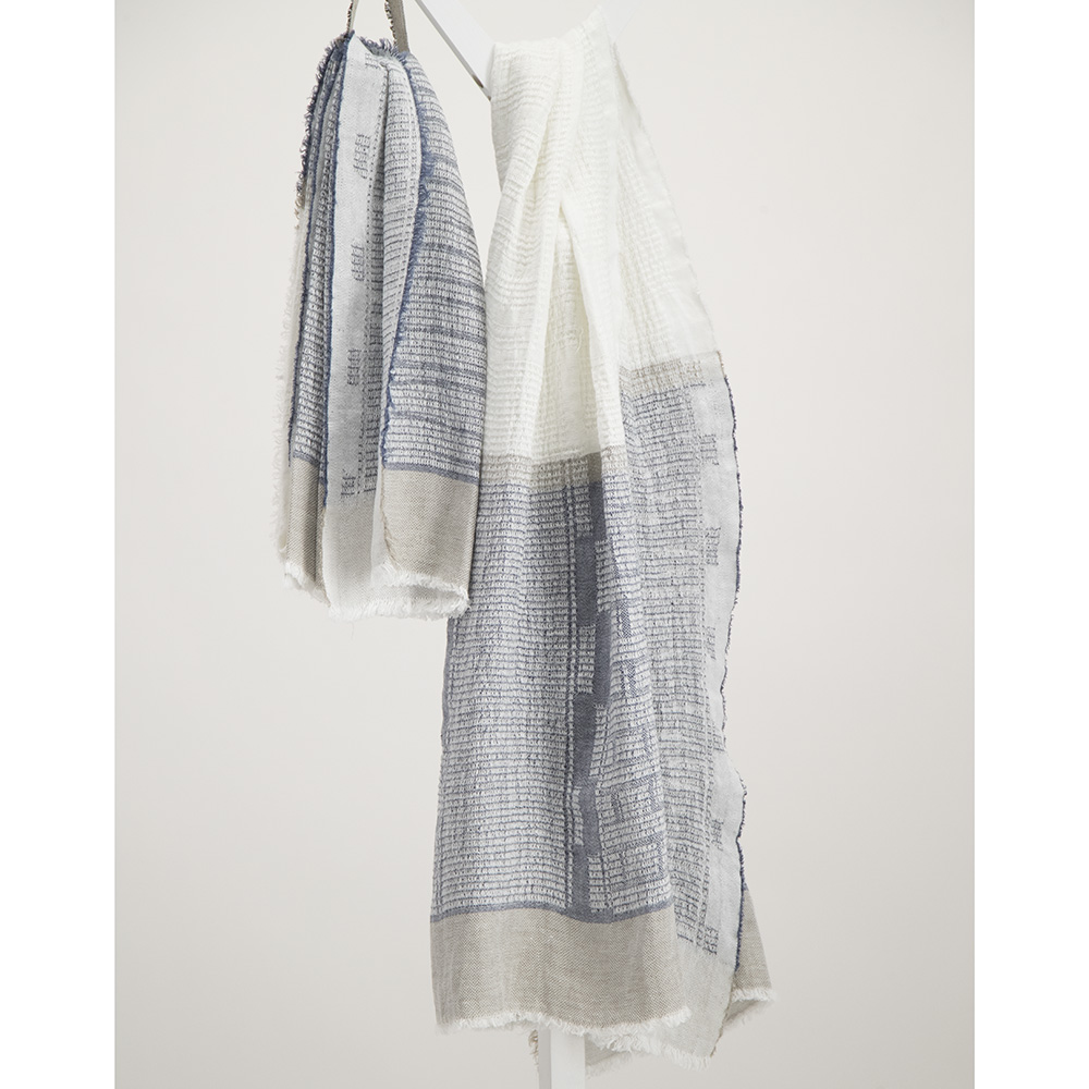 Navy and white bogowrap linen scarf hanged on a coat rack
