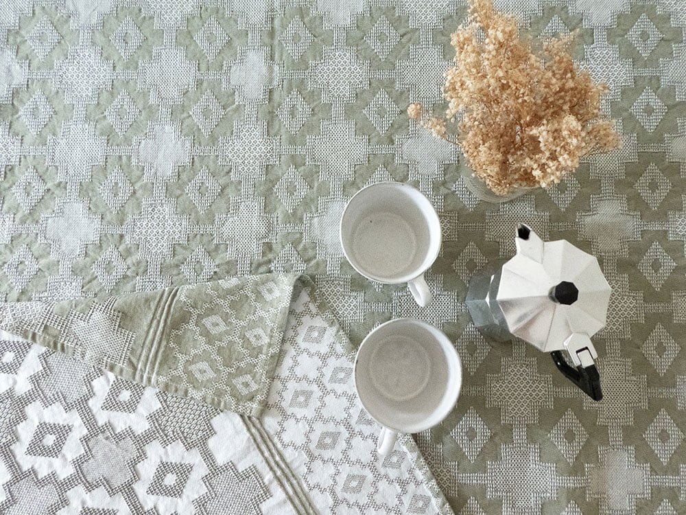 Customized tablecloth, jacquard woven in pale green with ethnic Kente designs