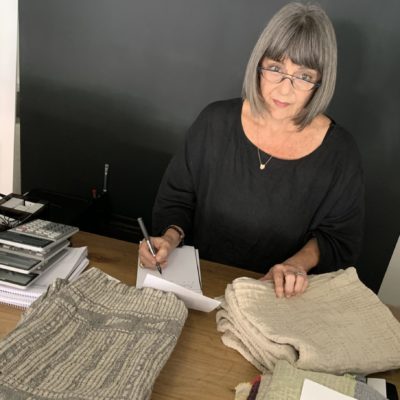 Paulibe Mutlow taking notes and exposing home textiles